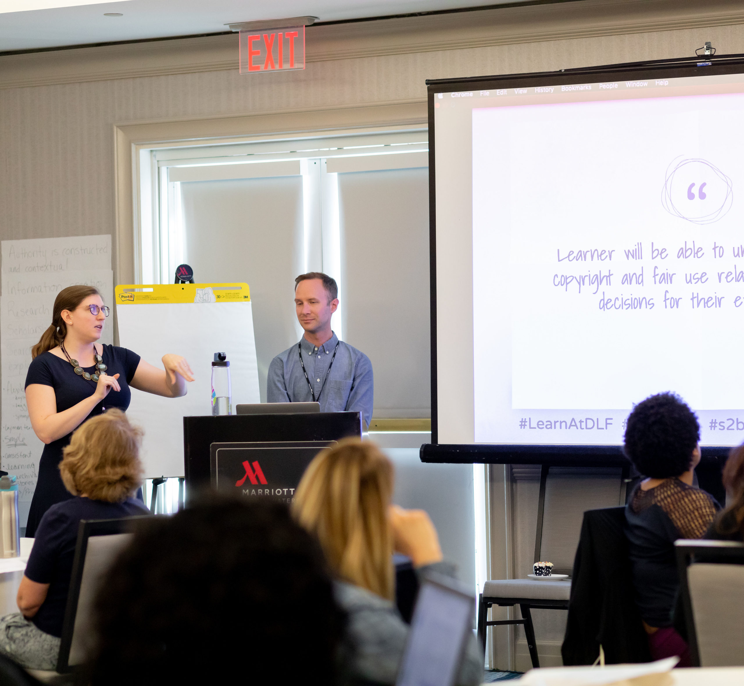 instructors explaining a concept to 2019 Learn@DLF workshop attendees